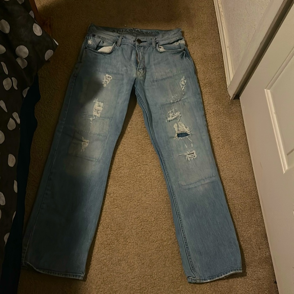 Light blue boot cut ripped jeans.